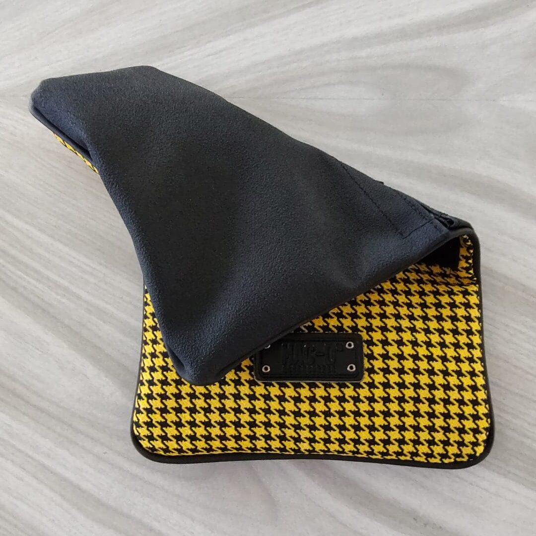 A black and yellow bag on the floor