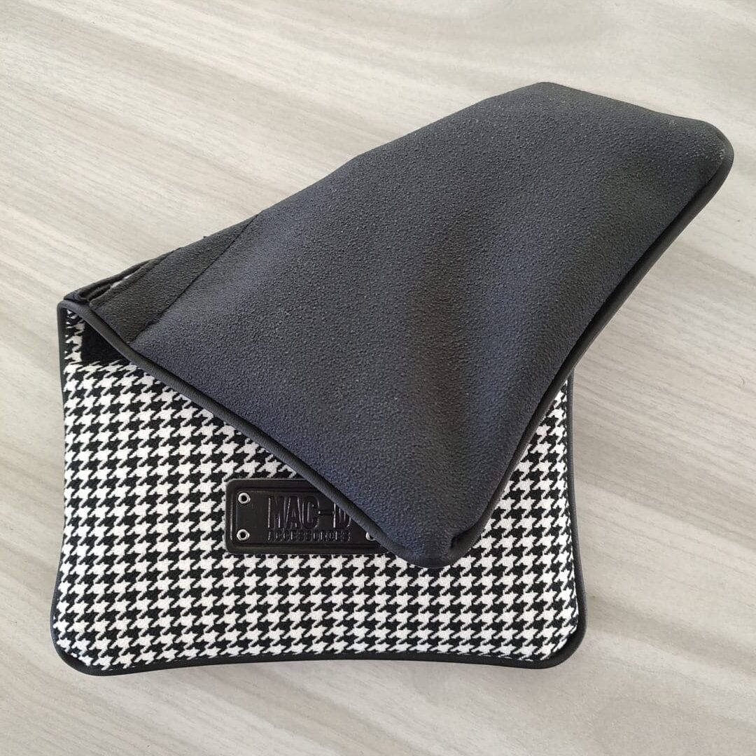 A black and white checkered purse sitting on top of a table.