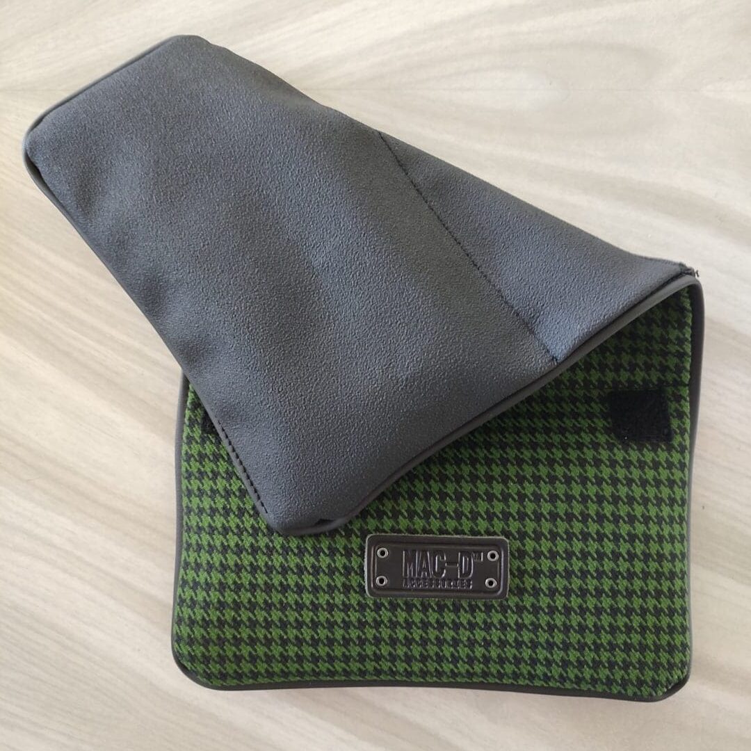 A green and black bag sitting on top of a table.